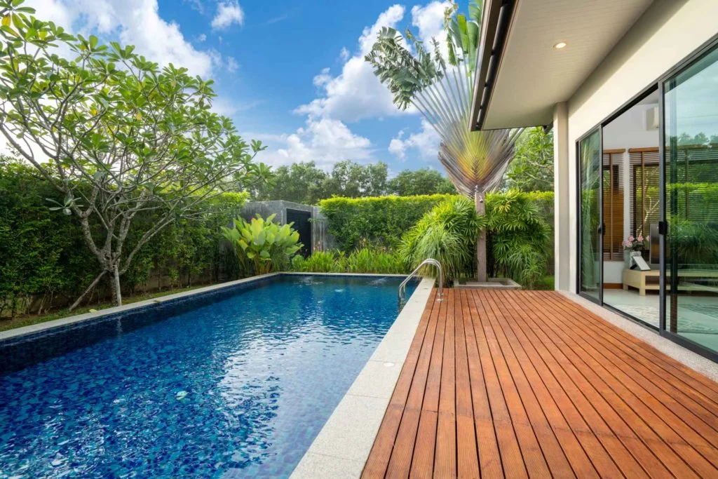 Poolside timber deck designed by Deck Builders Christchurch with trusted service from Fence Builders Christchurch.